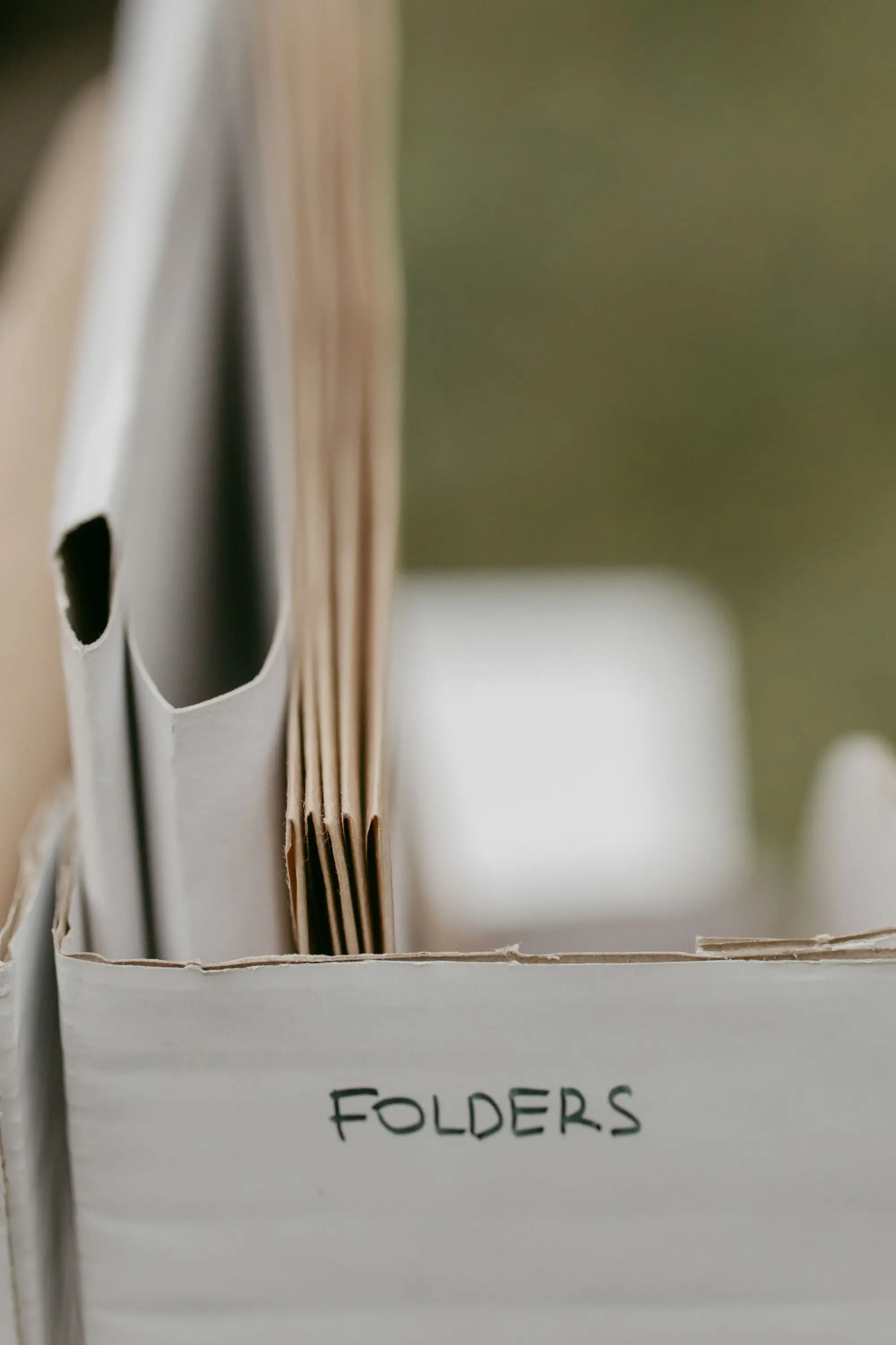 Folders filed upright in a box