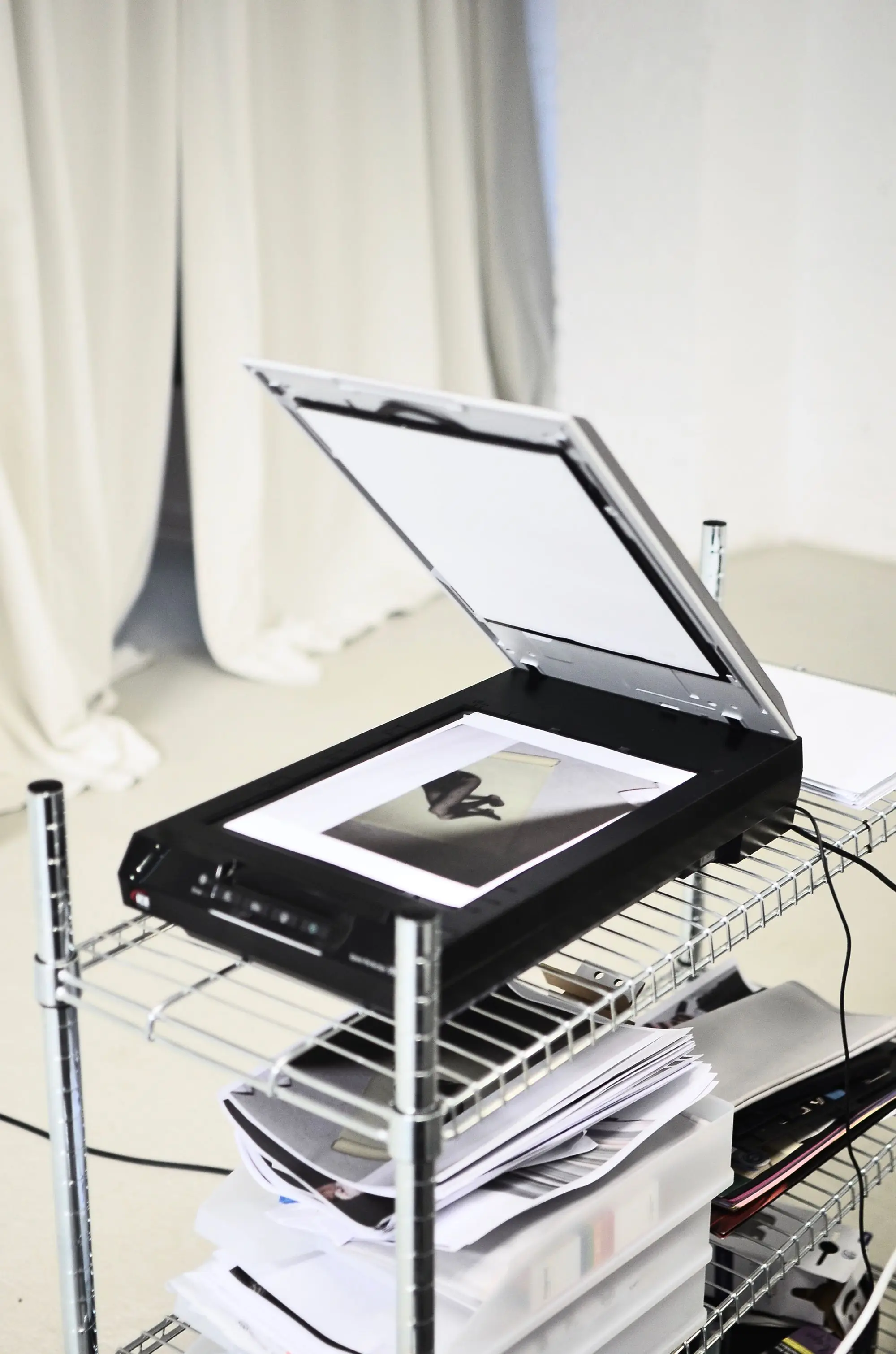 A document scanner on a shelf in a bright room
