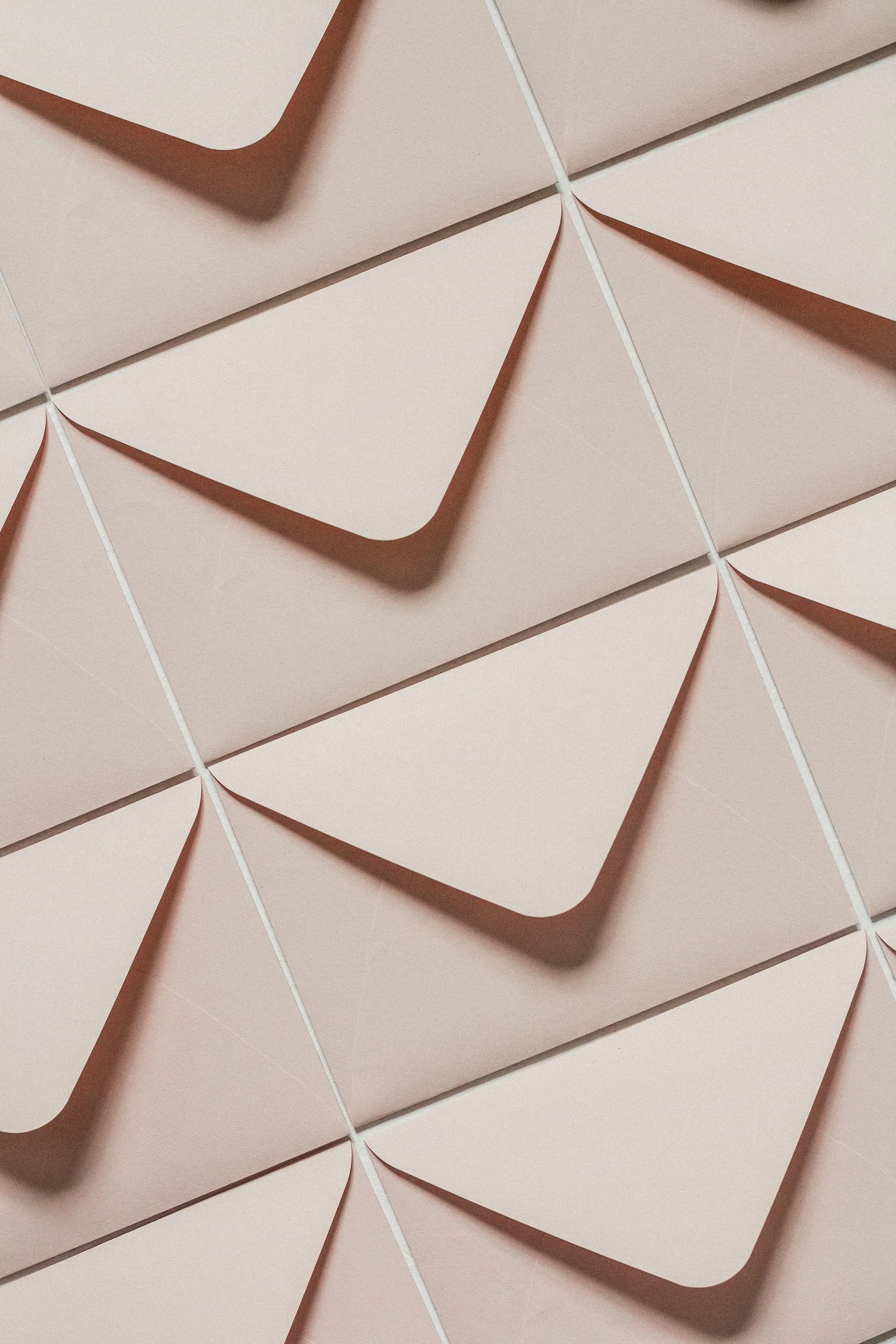 Rows of cream envelopes in warm light